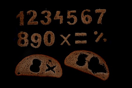 bread alphabet isolated on the black backgroundの写真素材
