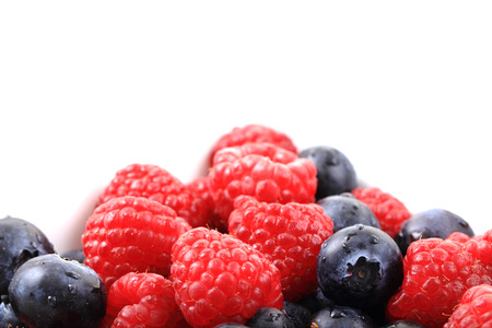 blueberries ad raspberries isolated on the white background