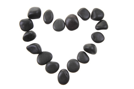 heart from the black stones isolated on the white backgroundの写真素材