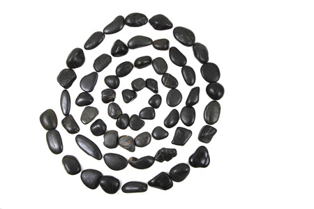 black stones spiral isolated on the white backgroundの写真素材