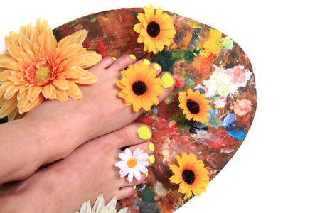 women feets and flowers as nice pedicure backgroundの写真素材