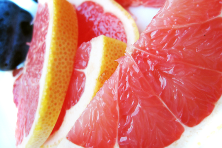 red grapefruit slices as nice fruit backgroundの写真素材