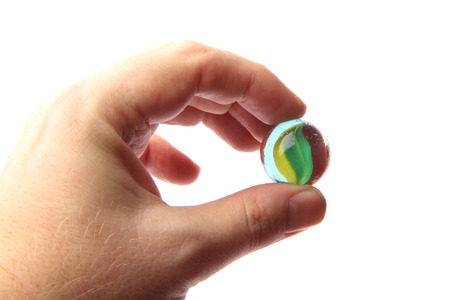 color glass sphere in the human hand isolated on the white backgroundの写真素材