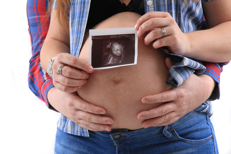 pregnancy woman with ultrasound photo as nice backgroundの写真素材