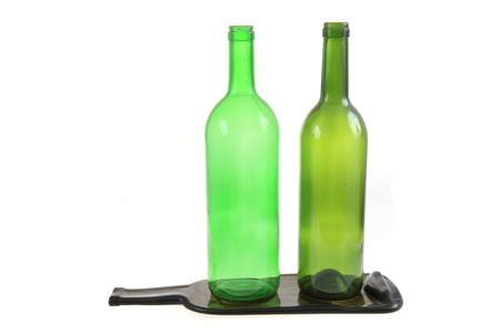 green glass bottles with one flat bottle isolated on the white backgroundの写真素材