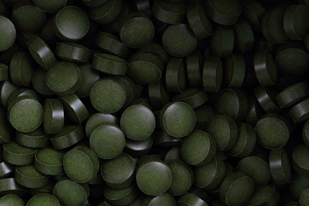 chlorella vulgaris tabs as nice natural medical backgroundの写真素材