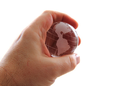 glass earth globe in human hand isolated on the white background