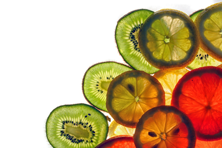 fresh fruit background from the slices of lemon, orange, kiwiの写真素材
