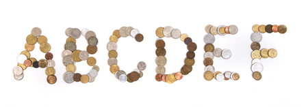alphabet from old european coins isolated on the white backgroundの写真素材