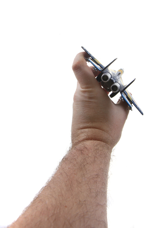air fighter toy in human hand isolated on the white backgroundの写真素材