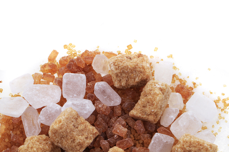 brown and white sugar isolated on white backgroundの写真素材