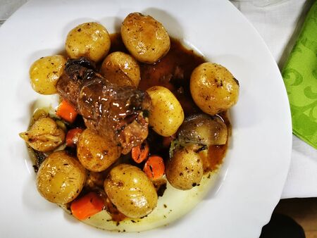 roasted fresh meat with whole small potatoesの写真素材