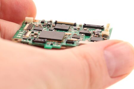 electronic chip in the hand isolated on white background