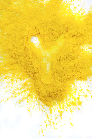 yellow laser powder isolated on the white backgroundの写真素材