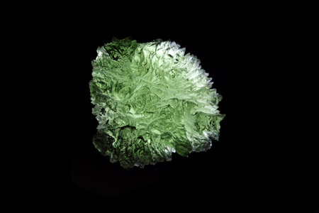 moldavite mineral isolated on the black backgroundの写真素材