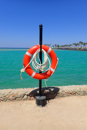 rescue ring on the Egyptian beach with the sea behind it