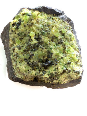 detail of natural olivine mineral isolated on the white backgroundの写真素材