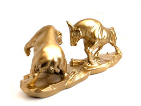 golden bull and bear as symbol of stock isolated on the white backgroundの写真素材