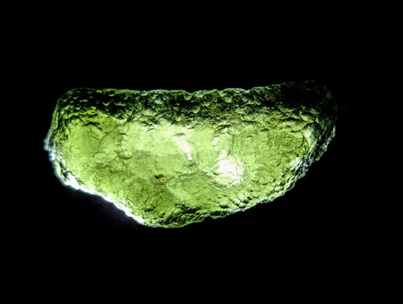 moldavite mineral isolated on the black backgroundの写真素材