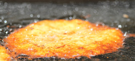 potato pancake in the pan with oil