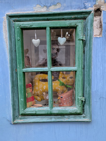 old green window in blue wall as nice backgroundの写真素材