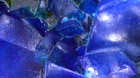 Detailed macro shot of deep blue mineral crystals, highlighting angular forms and reflective surfaces.