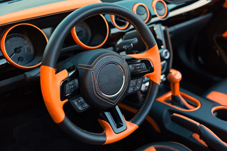 Sports car interior with orange accents. Photoの写真素材