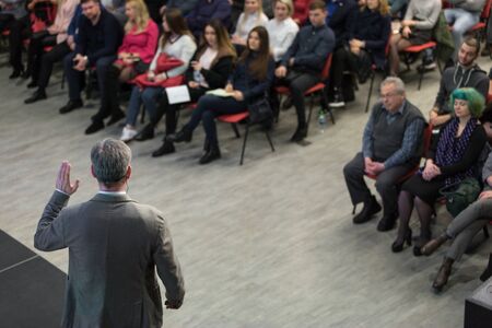 Chisinau, Republic of Moldova - March 11, 2018: speaker at Business Conference and Presentation. View from the back. Audience at the conference hall. Horizontally framed shot.のeditorial素材