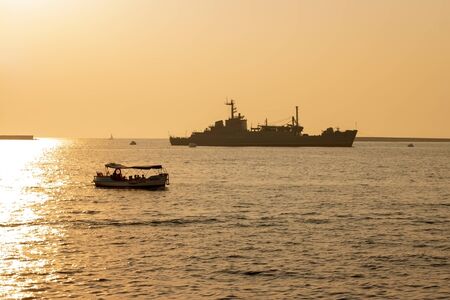 Sevastopol, Ukraine - July 30, 2011: The military ship General Ryabikov in the sea. Near the boat floats with tourists. Horizontally framed shot.のeditorial素材