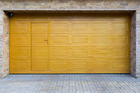 Yellow sectional garage door. Horizontally framed shot.の写真素材