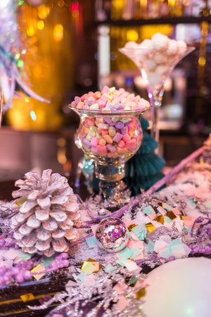 Christmas card, photo, background. Glasses of candy, cones of Christmas trees with Christmas tinsel, spruce branches. Place and background for text. Vertically framed shot.の写真素材