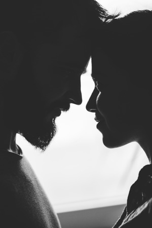Close portrait of a young couple. Man and woman in love. Cling to each other.の写真素材