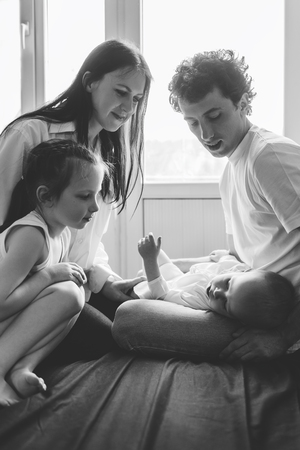 Parents and their children. Happy family life. Black and white photo.の写真素材