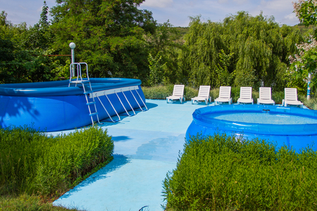 Recreation and swimming area. Two inflatable pools and sun loungers. Horizontally framed shot.の写真素材