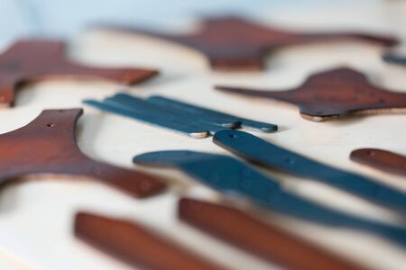 On a light wooden table leather straps. Horizontally framed shot.の写真素材