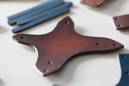 On a light wooden table leather straps. Horizontally framed shot.の写真素材