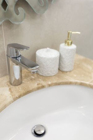 Marble sink, chrome faucet and bathroom accessories. Modern bathroom design. Horizontally framed shot. Vertically framed shot.の写真素材