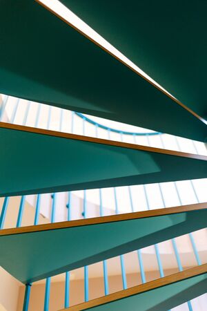Green wooden steps of a spiral staircase. Vertically framed shot.の写真素材