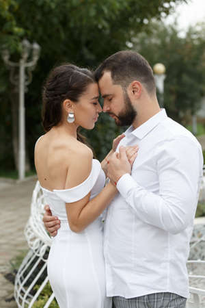 Stylish couple gently hugging. Happy sensual wedding couple embracing. Romantic moments of newlyweds. Vertically framed shot.の写真素材