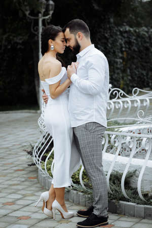 Stylish couple gently hugging. Happy sensual wedding couple embracing. Romantic moments of newlyweds. Vertically framed shot.の写真素材