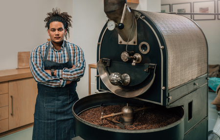 Entrepreneur in his modern well-kept coffee roastery and distribution factory