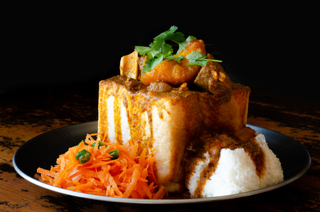 A Durban Bunny Chow - or, in this case, a quarter mutton bunny - served with sambals.の写真素材