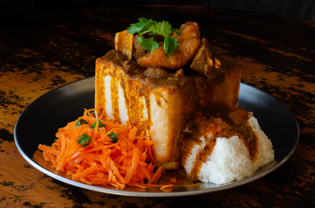 A Durban Bunny Chow - or, in this case, a quarter mutton bunny - served with sambals.の写真素材