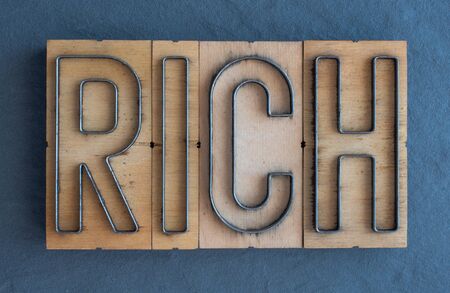 Old wood and steel number plate dies spell out the word RICHの写真素材