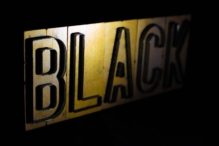Old wood and steel number plate dies spell out the word BLACKの写真素材