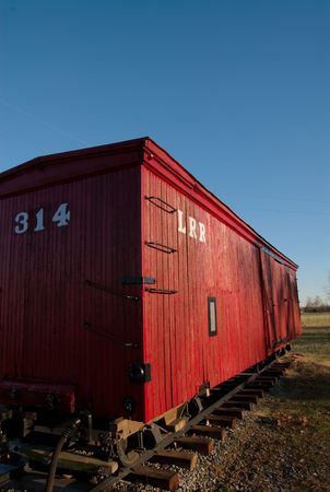 A caboose of a train sitting on the tracks.