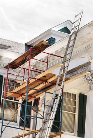 A white house being painted and reconstructed.の写真素材
