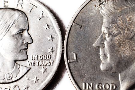 Two dollar coins facing each other.  Susan B. Anthony and John F. Kennedy.