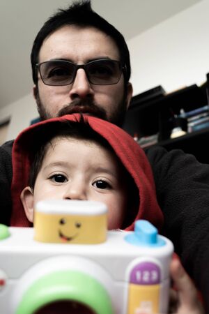 Father, son and cameraの写真素材