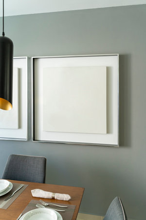 Modern house decoration, empty silver square frame, poster, white canvas, mock up, on a gray wall, ...